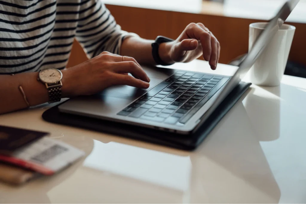 hands typing a laptop keyboard